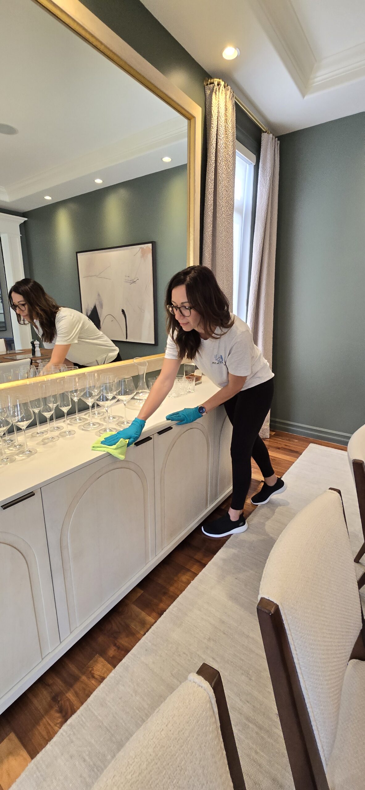 Taya wiping down a counter in an Edmonton dining room