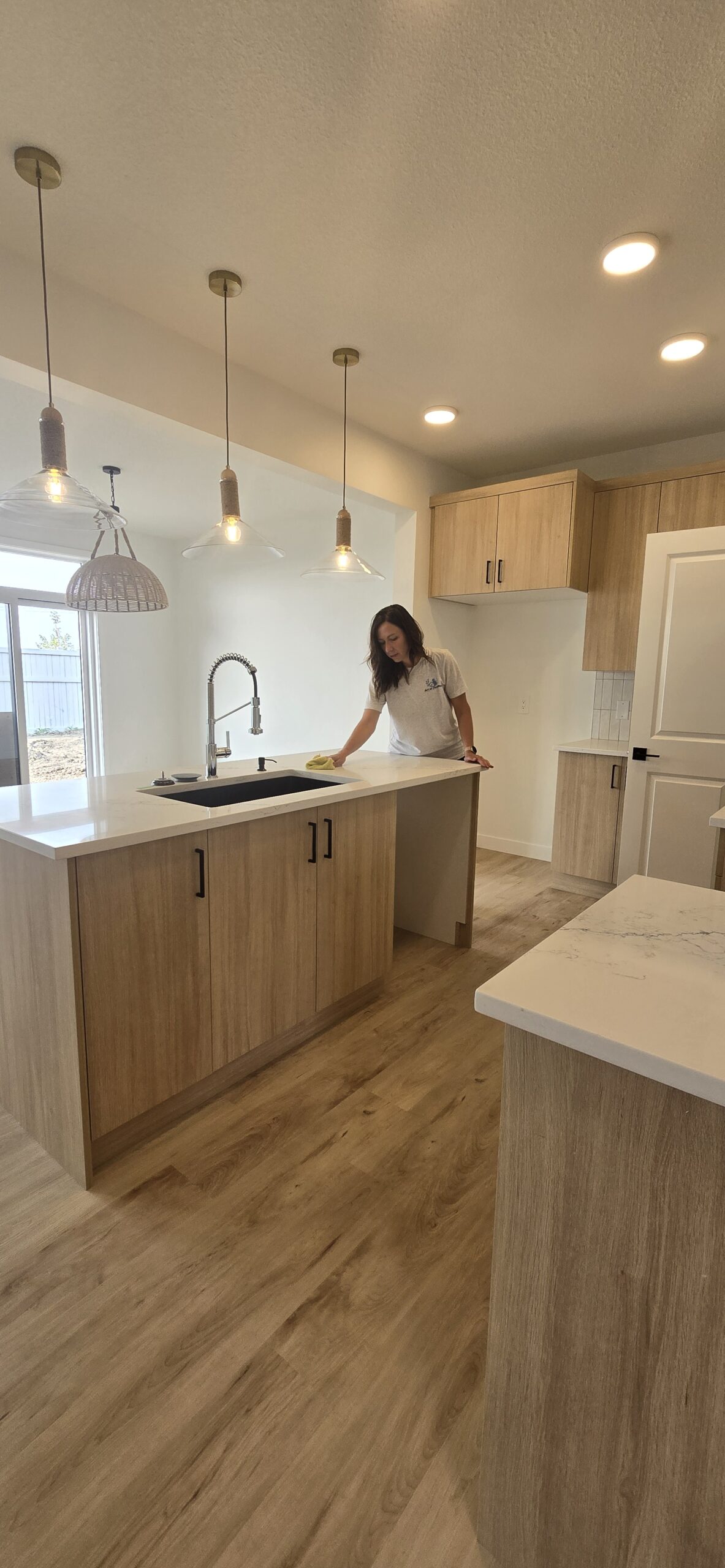 Taya cleaning a kitchen in Edmonton