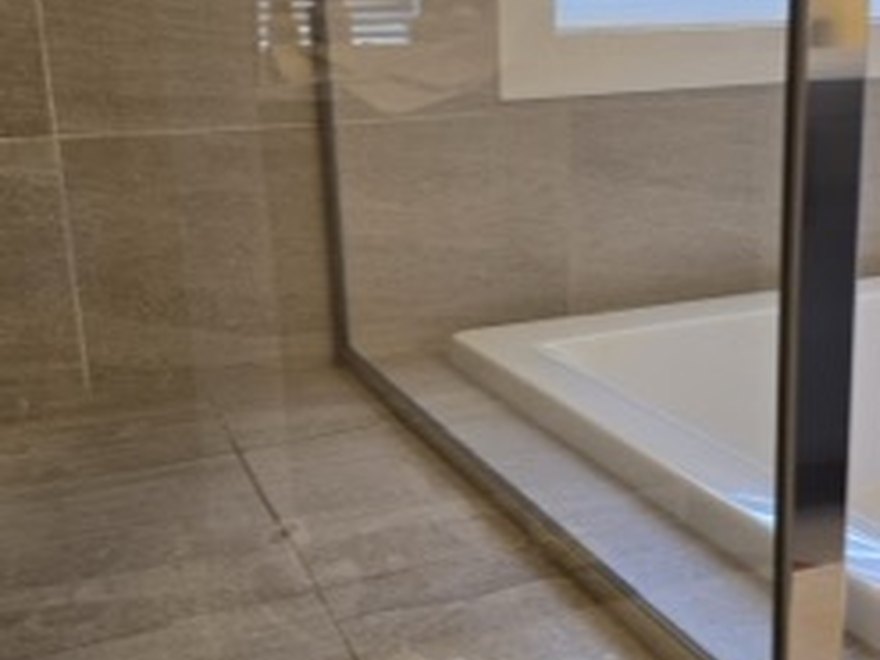 Glass shower door after — Art of CleaNest Edmonton