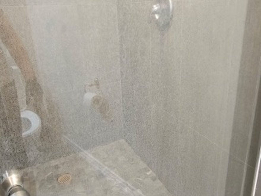 Tiled walk-in shower before — Art of CleaNest Edmonton